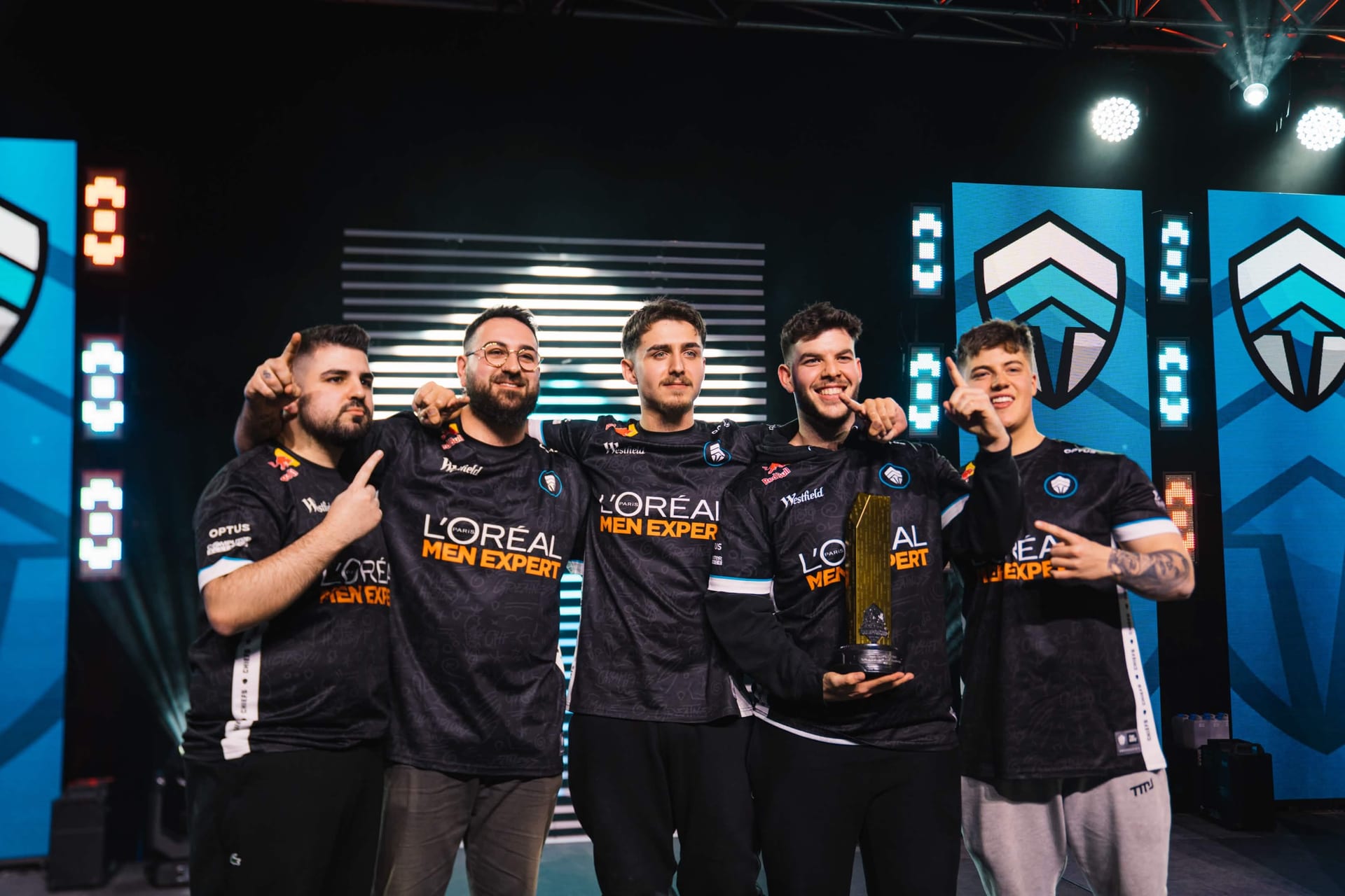 Chiefs Esports Club roster posing with the championship trophy in their L'Oreal Men Expert jerseys