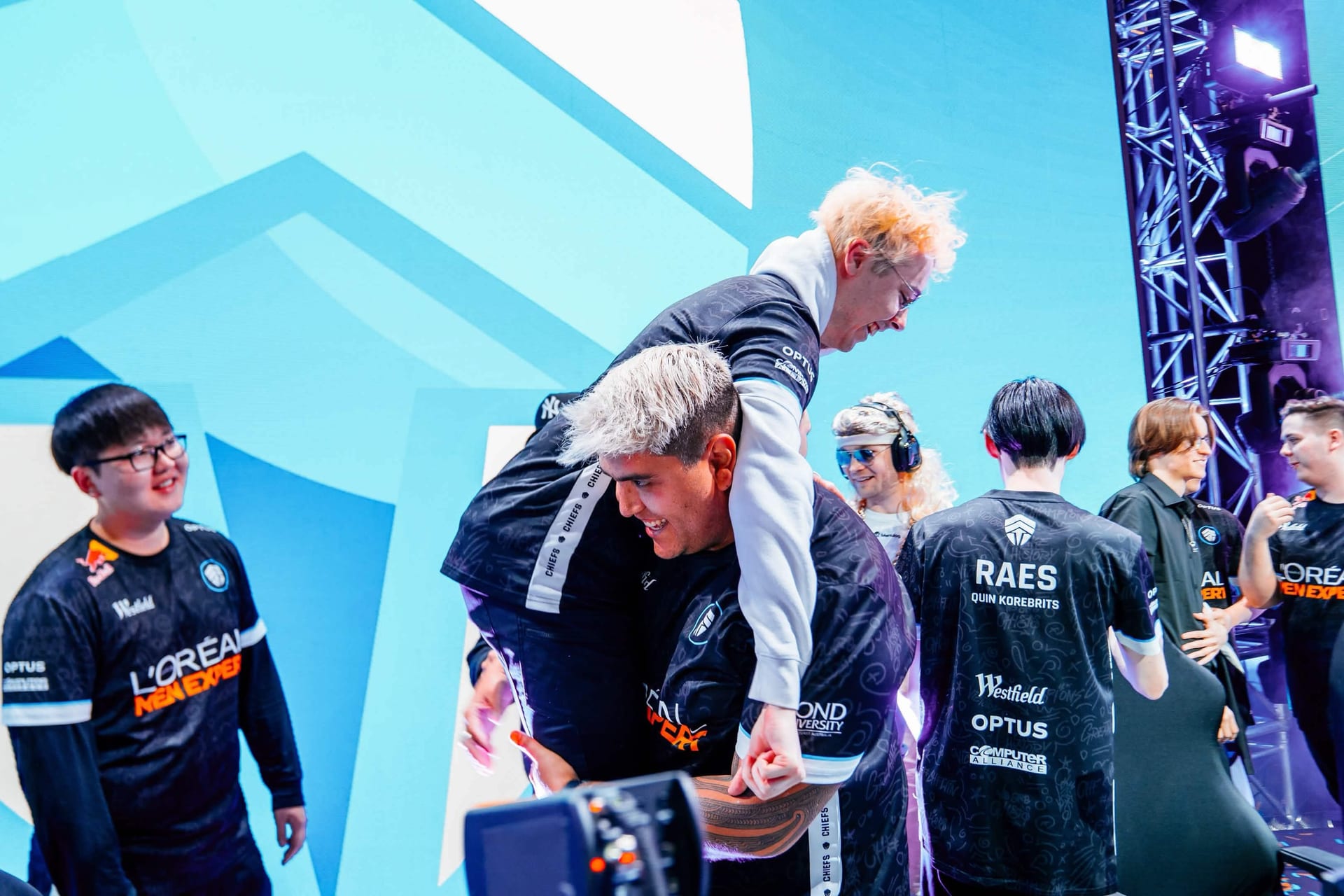 Chiefs Esports Club members holding the LCO trophy together on stage