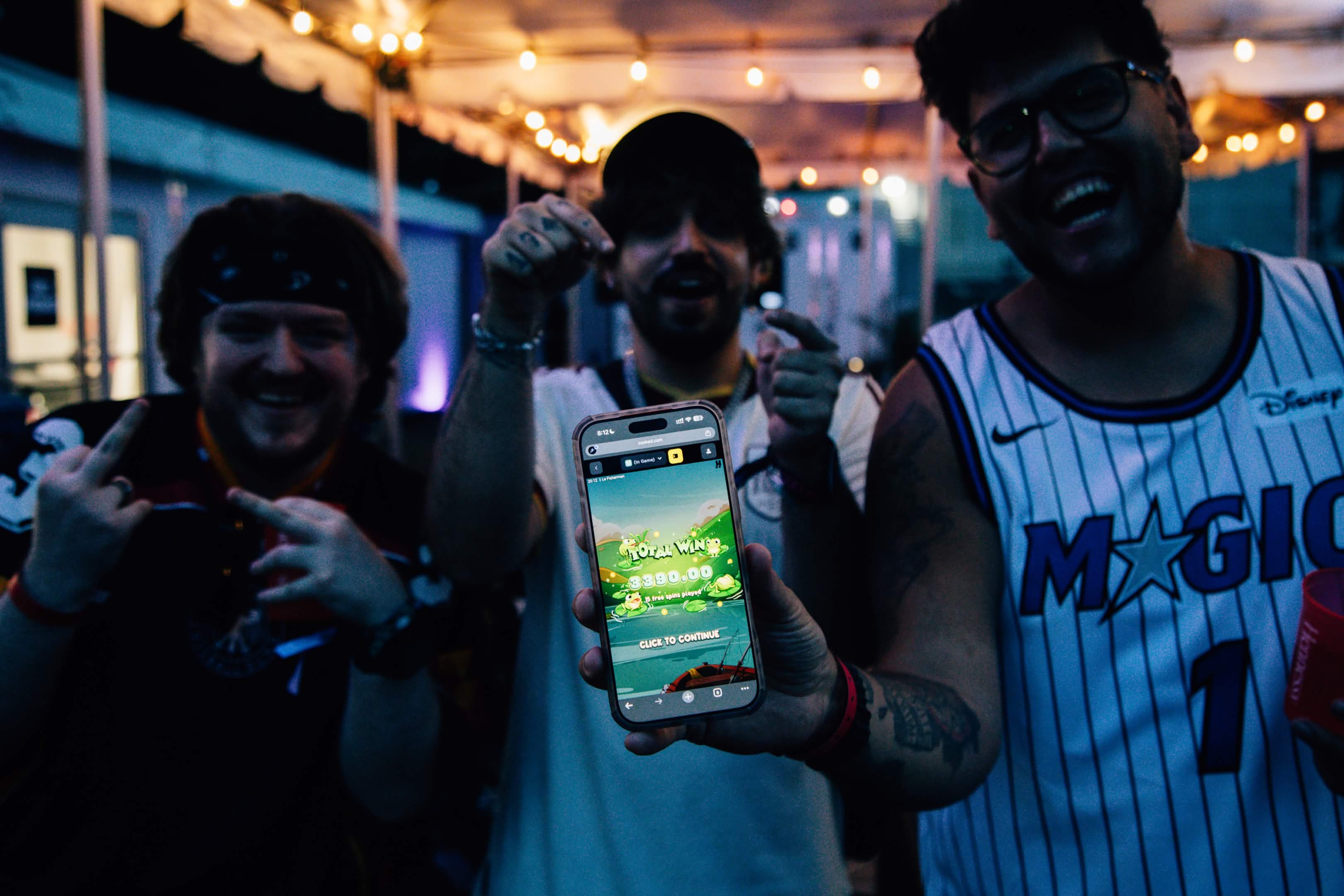 Attendees celebrating a win on the Cooked.com app at Rolling Loud
