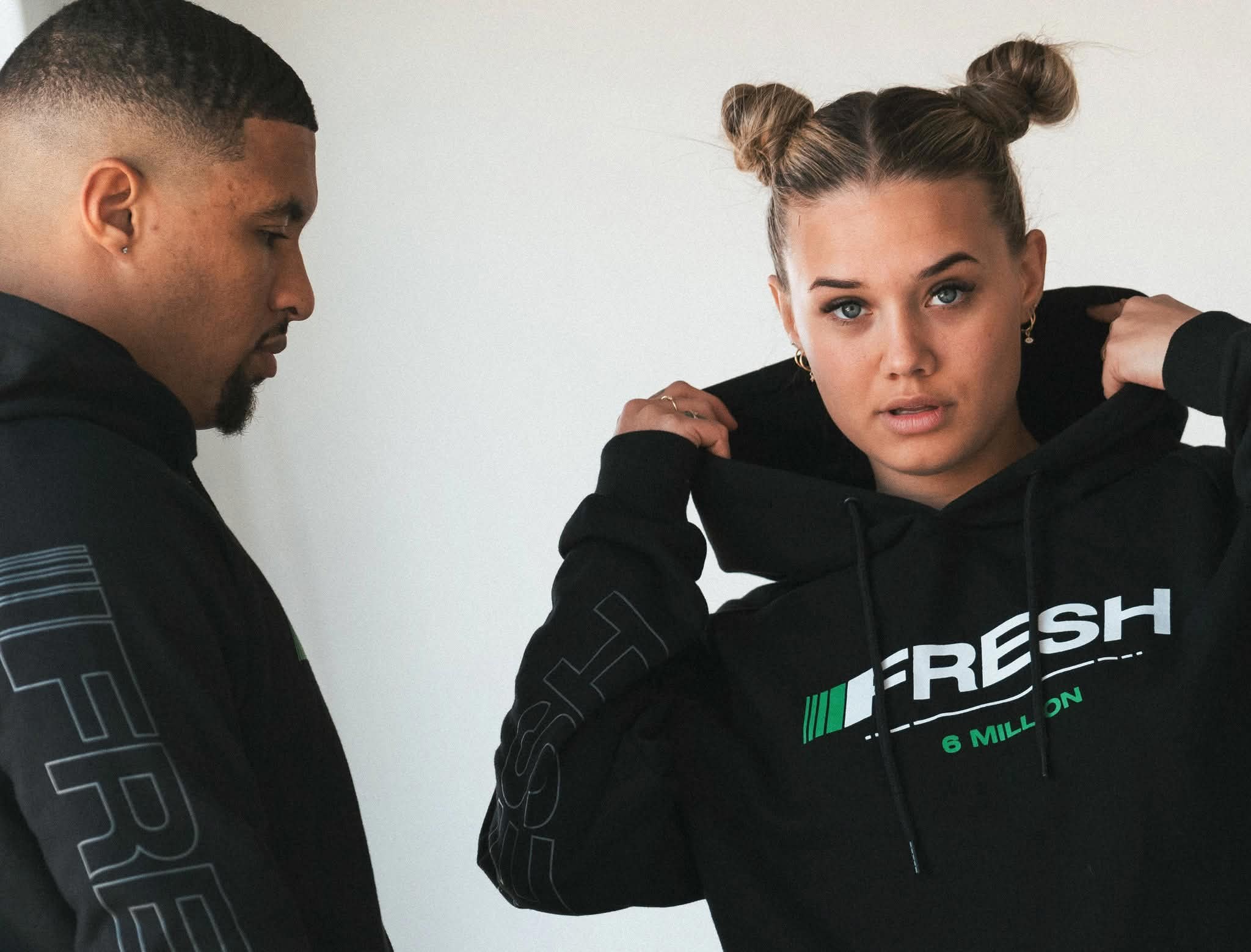 Two models in the FRESH 6 Million black hoodie drop produced by HYPR