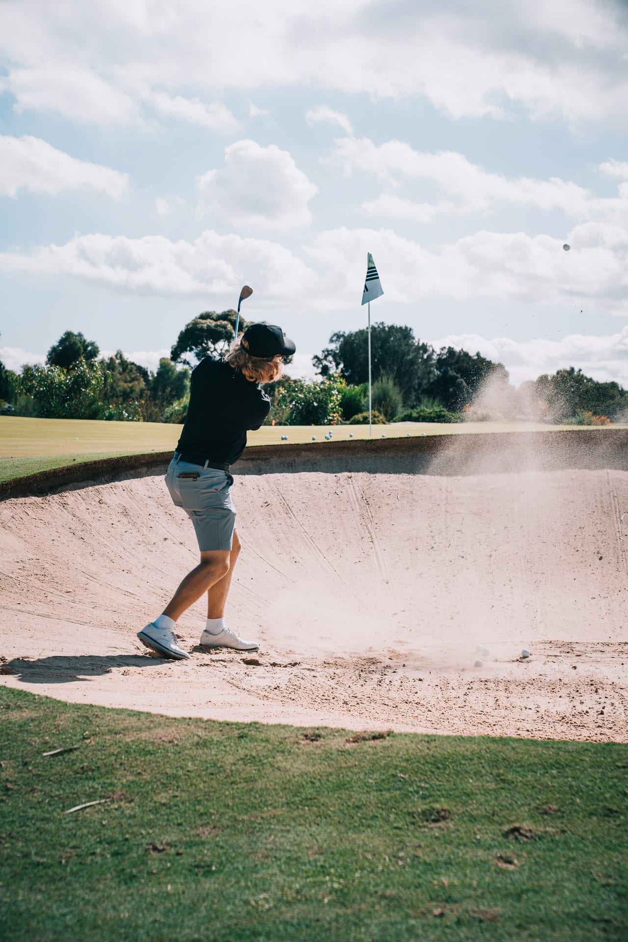 Golfer playing out of a bunker at LIV Golf Adelaide
