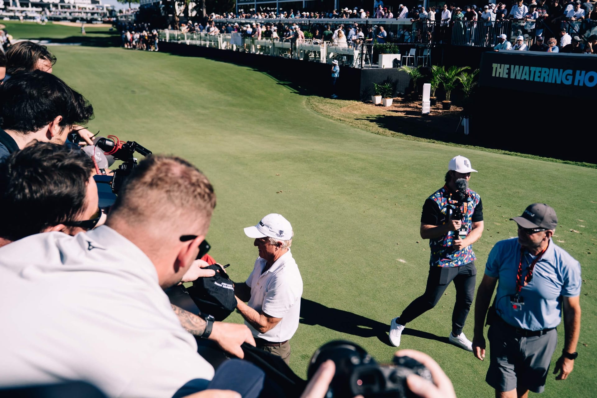 LIV Golf CEO Greg Norman signing for media as Mitch Robinson films at LIV Golf Adelaide