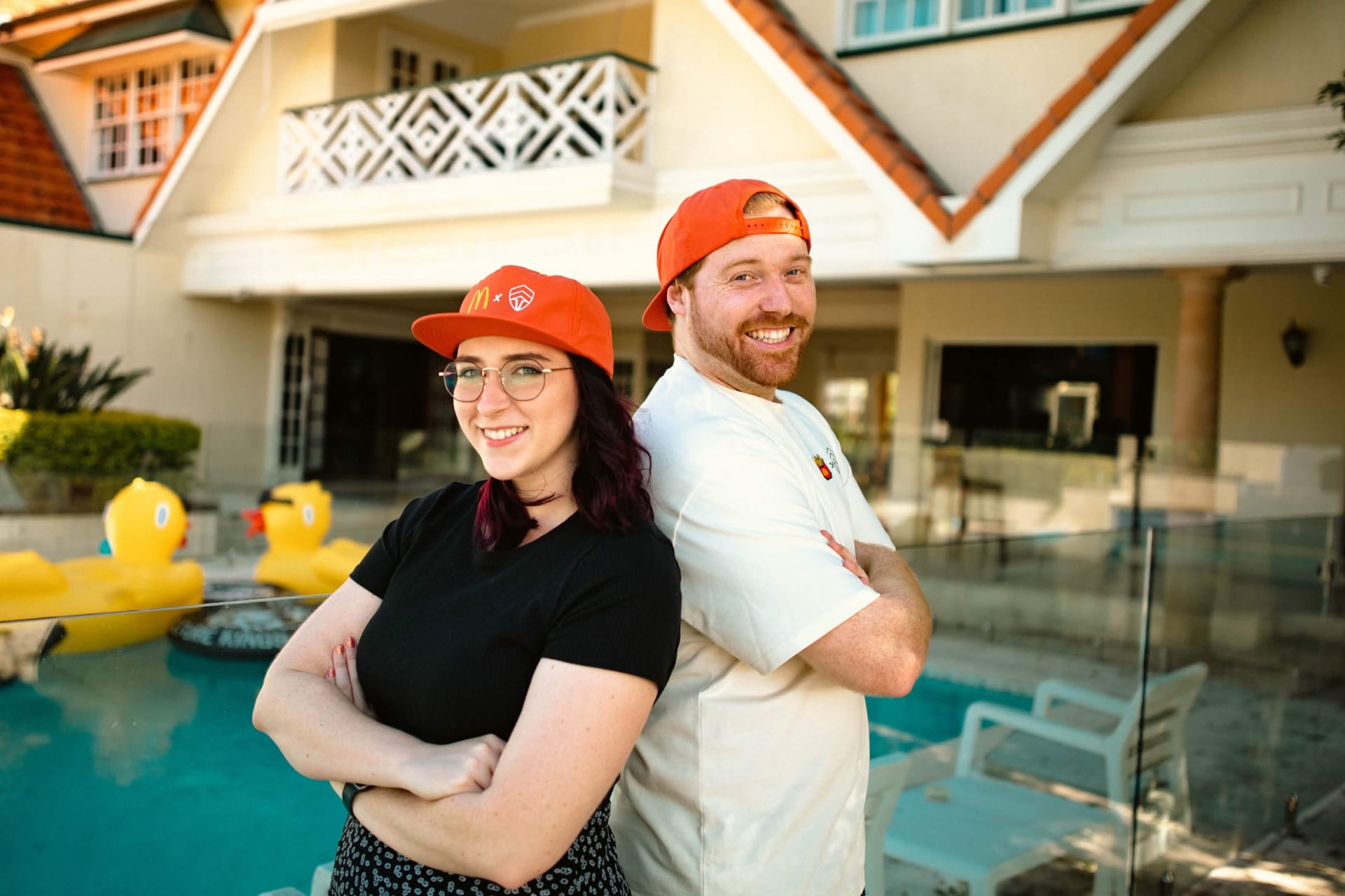 Creators in McDonald's x Chiefs orange caps at the Summer of Gaming pool party activation