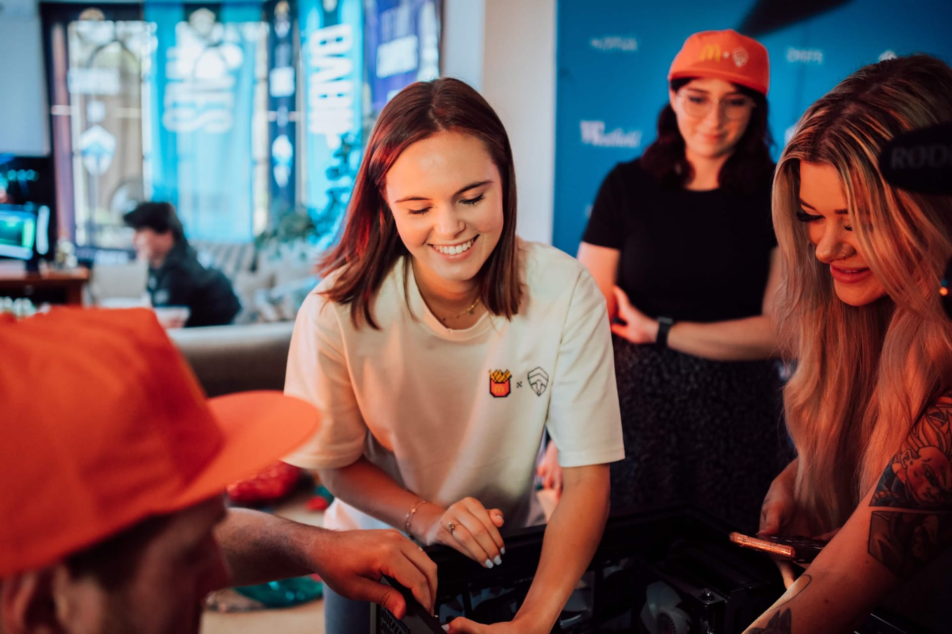 Creators unboxing gaming hardware in McDonald's x Chiefs merch at the Summer of Gaming activation