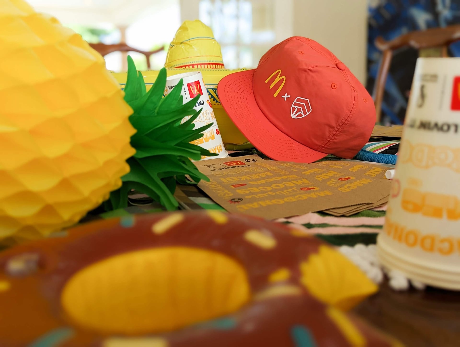 McDonald's x Chiefs Summer of Gaming merch and props styled on a table