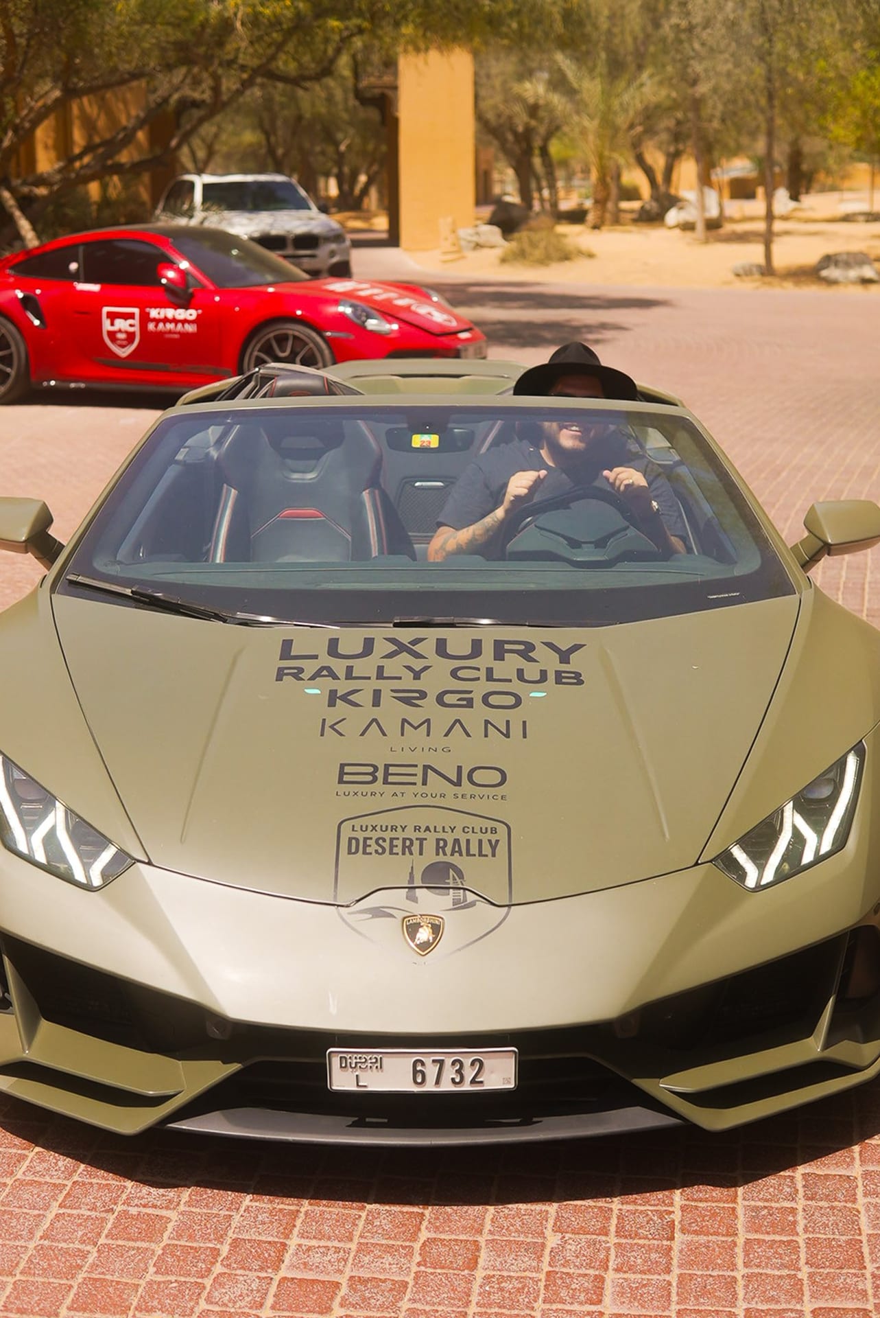 Luxury Rally Club branded Lamborghini and Porsche lined up at the HYPR produced UAE Desert Rally